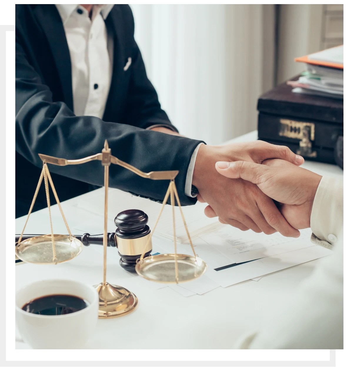 Lawyers shaking hands in office setting